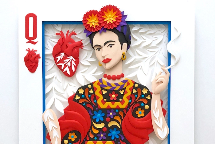 A paper-cut portrait of Frida Kahlo, styled as a playing card Queen of Hearts.